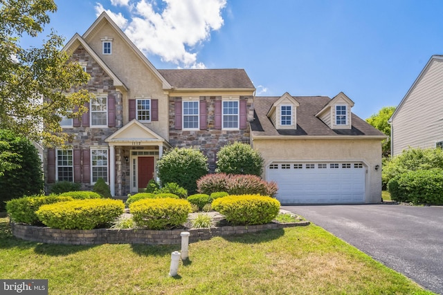 view of front of property with a garage and a front yard