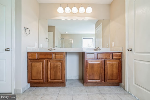 bathroom featuring vanity, an enclosed shower, and tile patterned floors