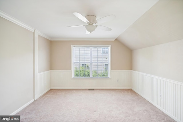 additional living space featuring lofted ceiling, light carpet, and ceiling fan