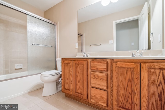 full bathroom featuring vanity, tile patterned floors, enclosed tub / shower combo, and toilet