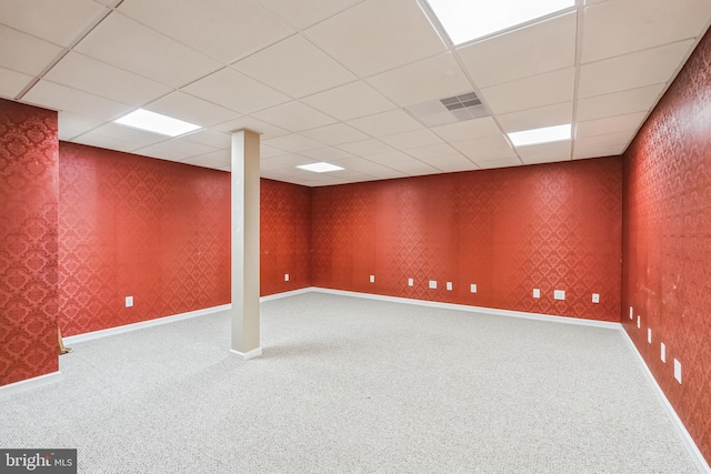 basement featuring carpet and a paneled ceiling