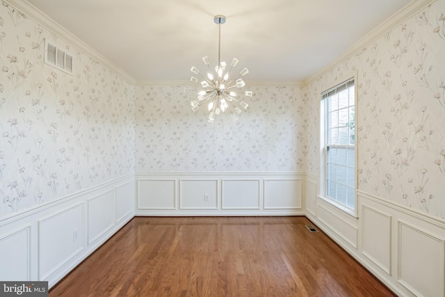 unfurnished dining area with an inviting chandelier, wood-type flooring, and ornamental molding