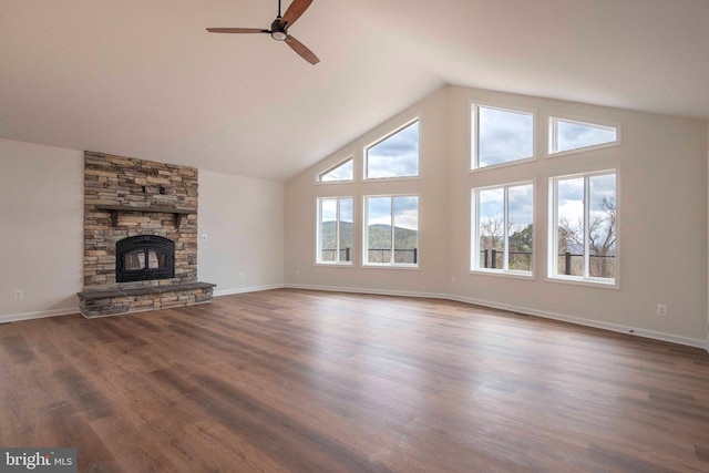 unfurnished living room with baseboards, a ceiling fan, dark wood-type flooring, a fireplace, and high vaulted ceiling