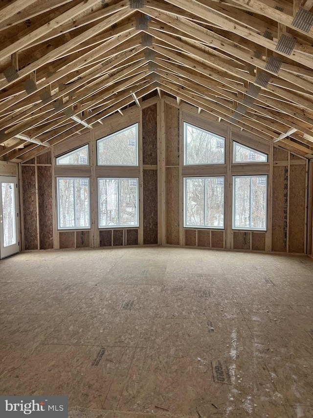 misc room with a healthy amount of sunlight and vaulted ceiling