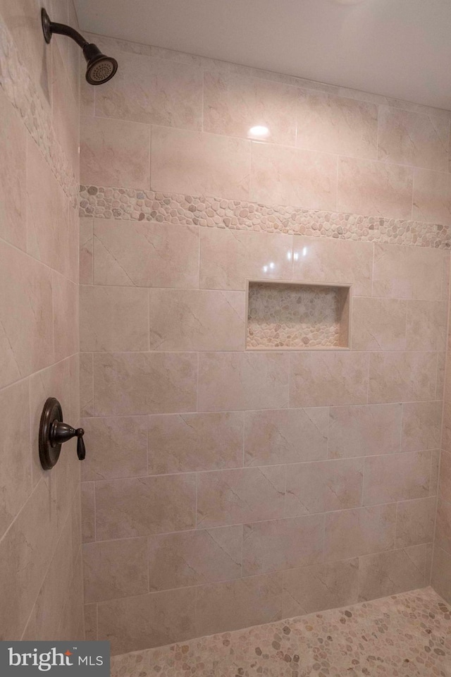 bathroom with tiled shower