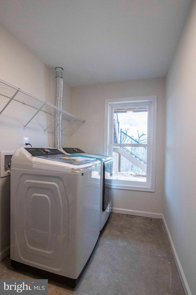 laundry room with baseboards, laundry area, and washer and dryer