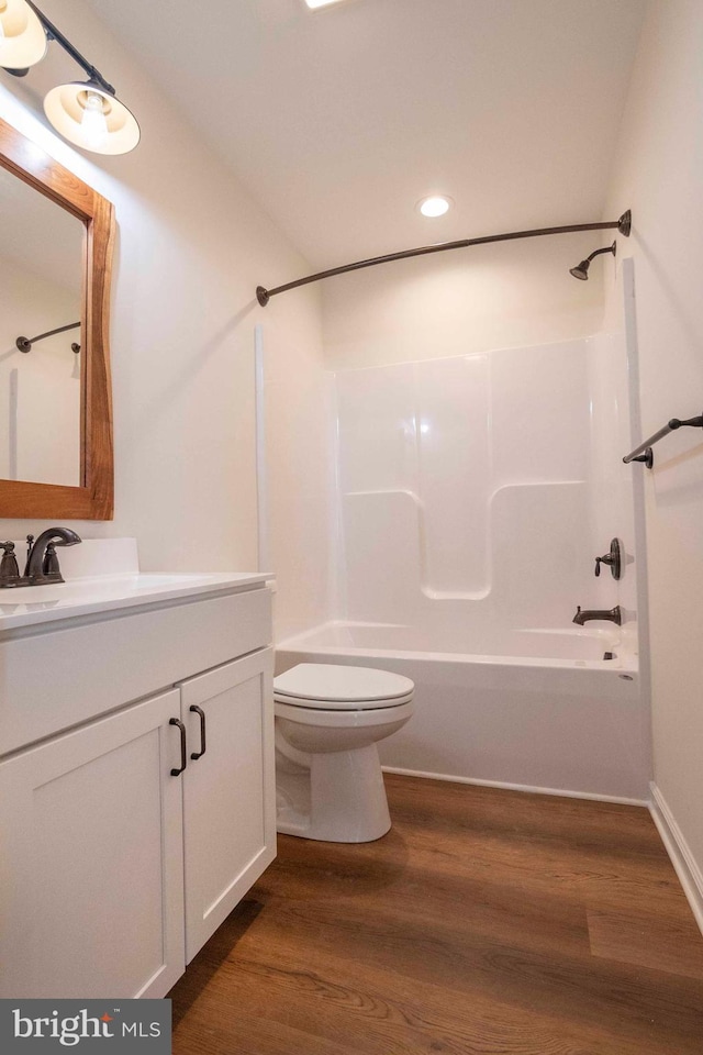 full bathroom with recessed lighting, shower / bathing tub combination, toilet, vanity, and wood finished floors