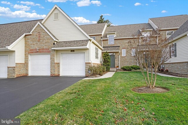 view of front facade with a front yard and a garage