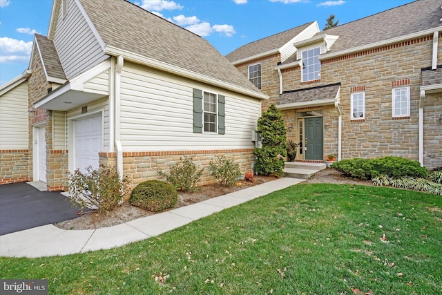 view of front of home featuring a garage and a front lawn