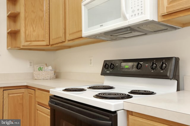 kitchen featuring range with electric cooktop and light brown cabinetry