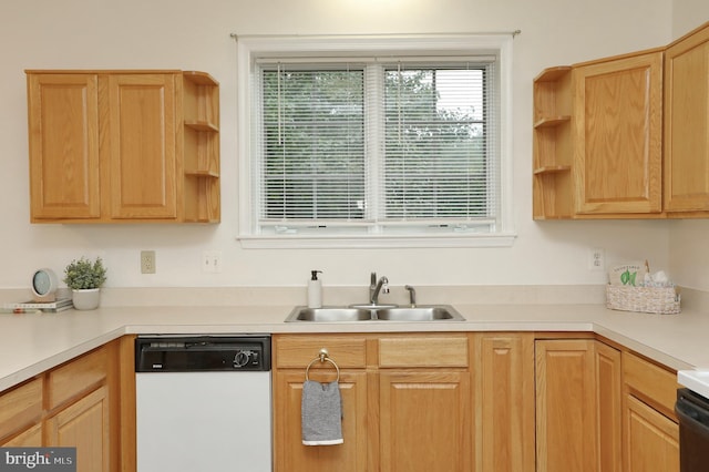 kitchen with sink, light brown cabinetry, and white dishwasher