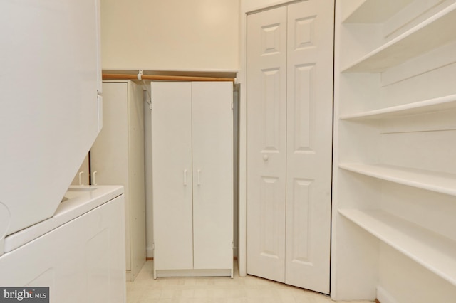 laundry area featuring stacked washer and clothes dryer