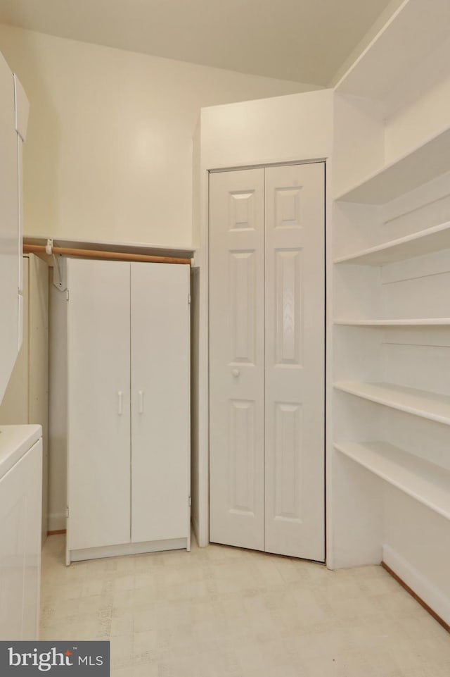 interior space featuring stacked washing maching and dryer