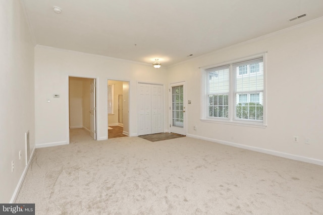 unfurnished bedroom with ornamental molding, light carpet, and connected bathroom