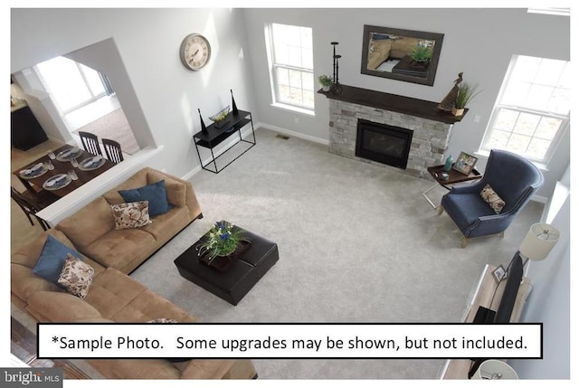 living room with a fireplace and carpet