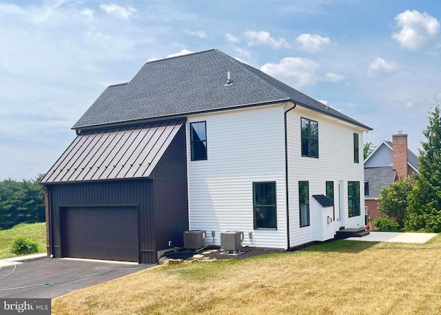 exterior space featuring a yard and central air condition unit