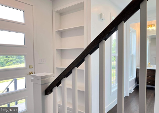 staircase with dark hardwood / wood-style flooring and a wealth of natural light