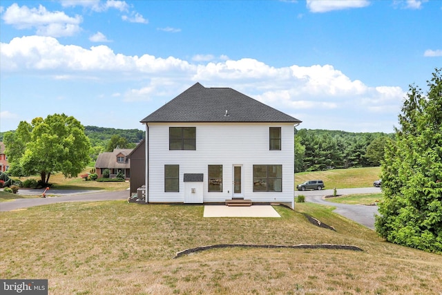 back of house featuring a patio and a lawn