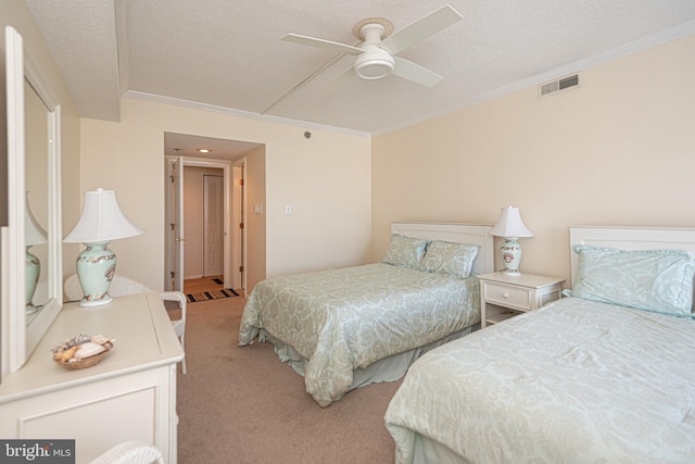 carpeted bedroom with a textured ceiling, ornamental molding, and ceiling fan