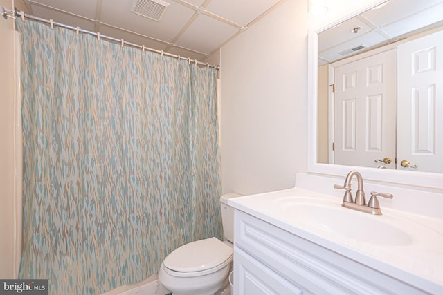 bathroom featuring vanity, curtained shower, and toilet