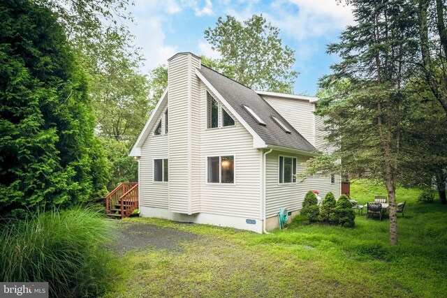 view of home's exterior with a yard