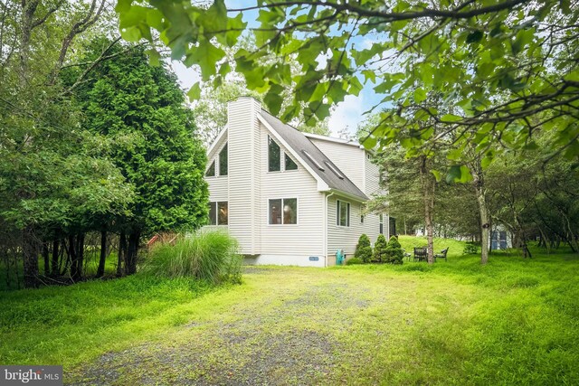 view of home's exterior with a yard