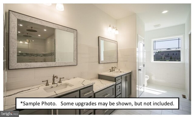 bathroom with vanity, tile walls, tasteful backsplash, and toilet