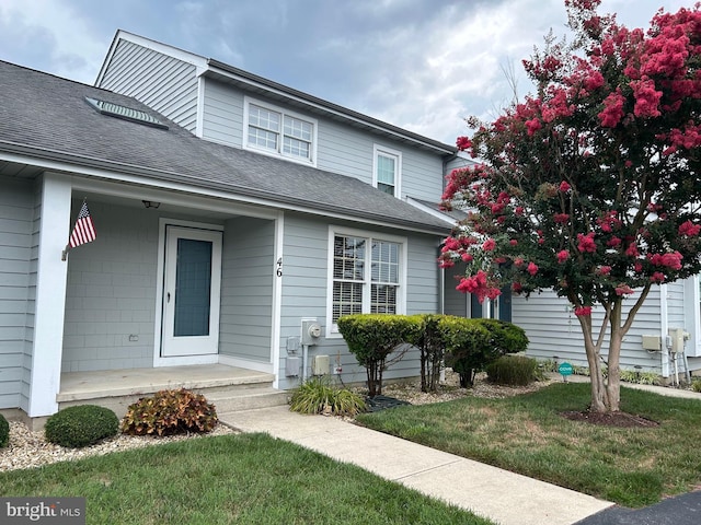 view of front of property with covered porch and a front lawn