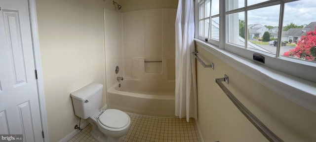 bathroom featuring shower / tub combo, tile patterned flooring, and toilet