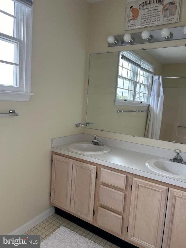 bathroom with double vanity and tile patterned floors