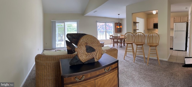 carpeted living room with lofted ceiling