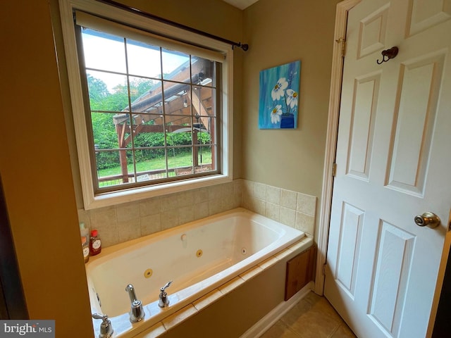 bathroom featuring tiled tub and tile patterned flooring