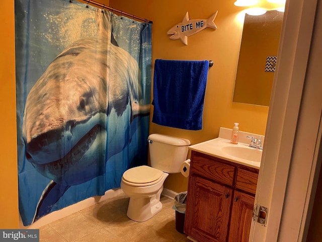 bathroom featuring vanity, tile patterned flooring, and toilet