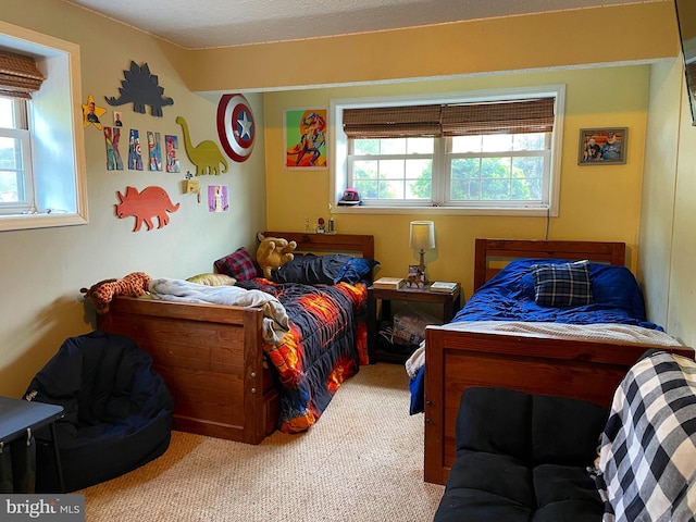 carpeted bedroom featuring a textured ceiling