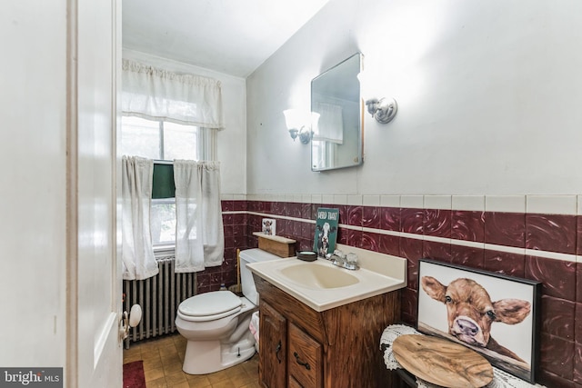 1757 Shadyside Rd, Downingtown, PA 19335 - half bathroom featuring vanity, tile walls, toilet, a wainscoted wall, and radiator heating unit
