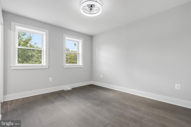 empty room with dark wood-type flooring