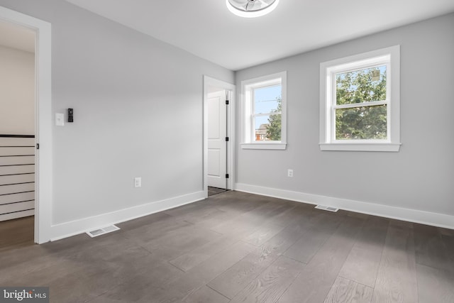 spare room featuring dark hardwood / wood-style flooring