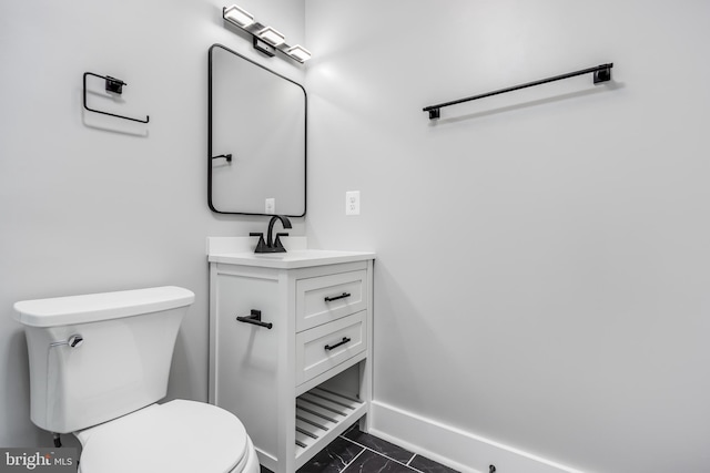 bathroom with toilet, tile patterned flooring, and vanity