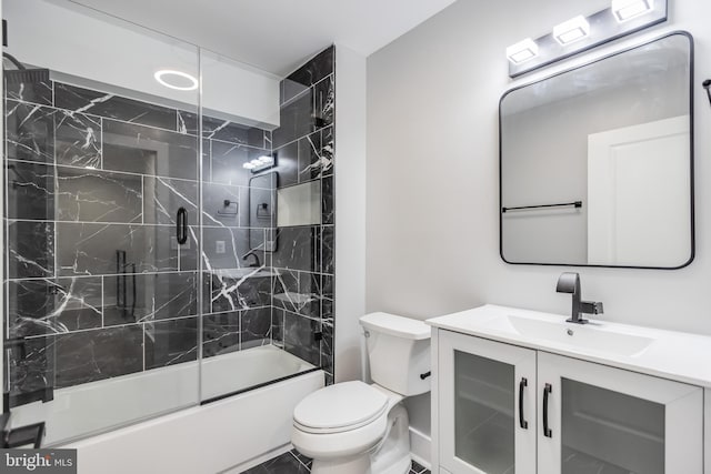 full bathroom with tile patterned flooring, combined bath / shower with glass door, toilet, and vanity