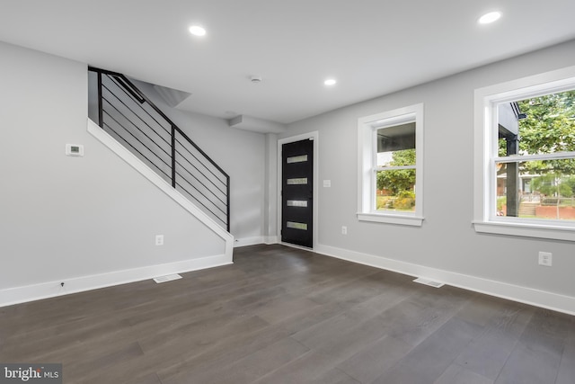 foyer entrance featuring dark hardwood / wood-style flooring and a healthy amount of sunlight