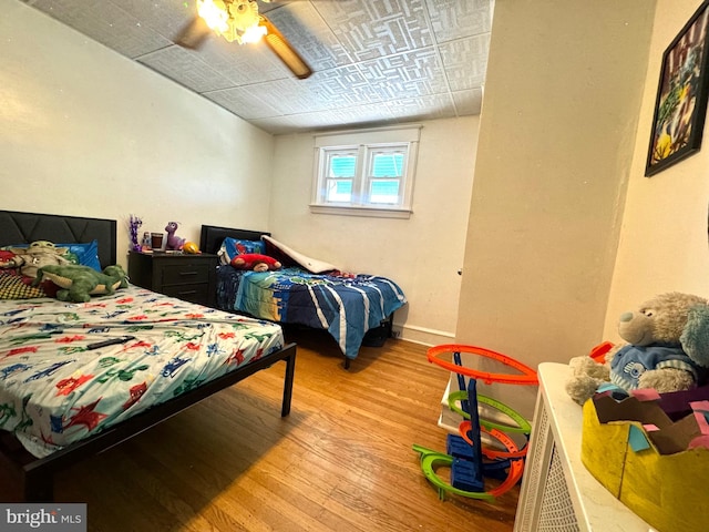 bedroom featuring light hardwood / wood-style flooring and ceiling fan