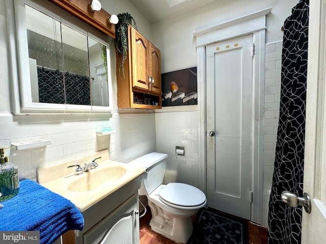 bathroom featuring tile walls, backsplash, vanity, and toilet