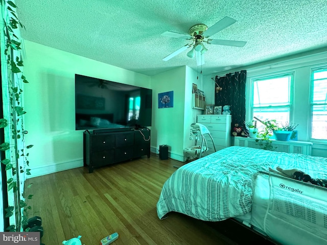 bedroom featuring ceiling fan, a textured ceiling, and wood-type flooring