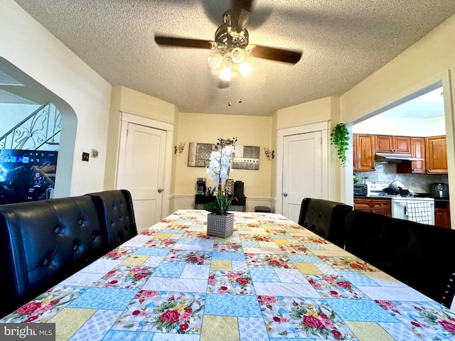 dining room with a textured ceiling and ceiling fan