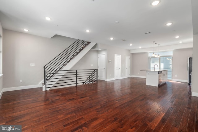 unfurnished living room featuring dark wood-type flooring