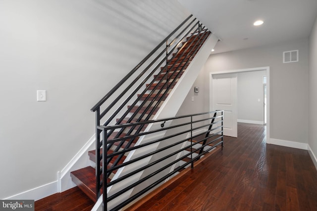 stairs featuring hardwood / wood-style flooring