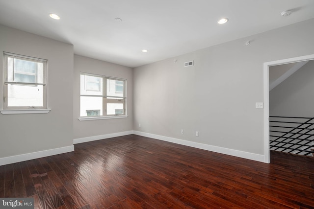 unfurnished room featuring dark wood-type flooring