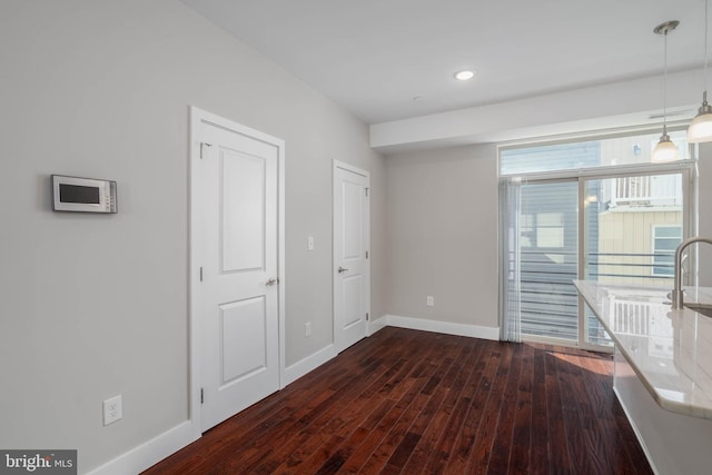 unfurnished room featuring dark wood-type flooring