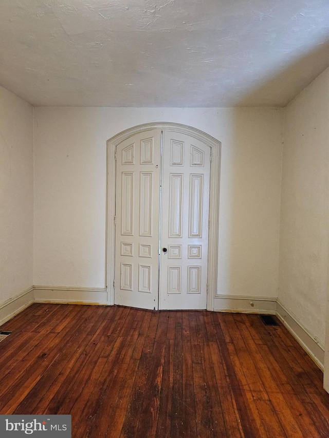 unfurnished bedroom with hardwood / wood-style floors