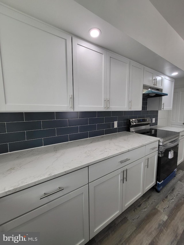 kitchen featuring tasteful backsplash, stainless steel electric range oven, dark hardwood / wood-style flooring, and white cabinetry